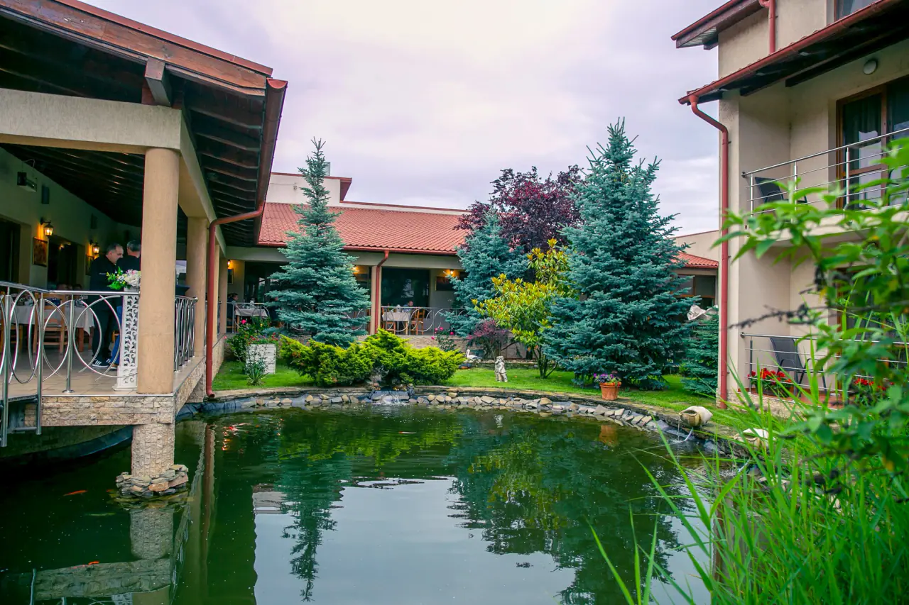 The fish lake and greenery around Hotel Astoria