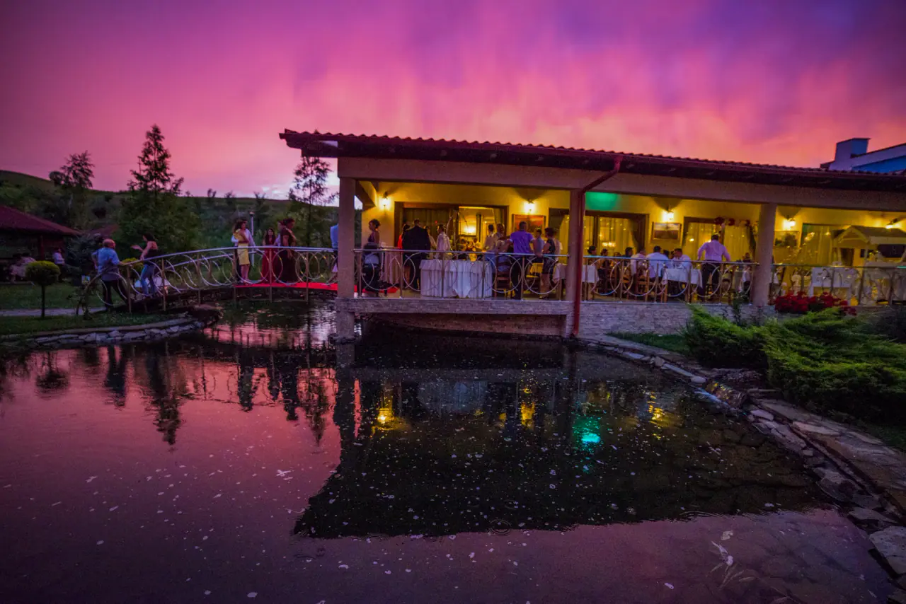 The Astoria restaurant terrace at dusk, mirrored in the lake
