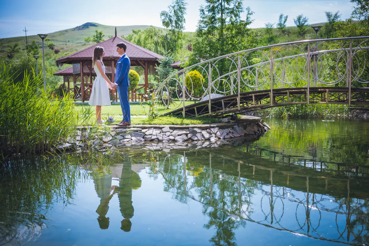 Newlyweds on the bridge over Hotel Astoria’s lake